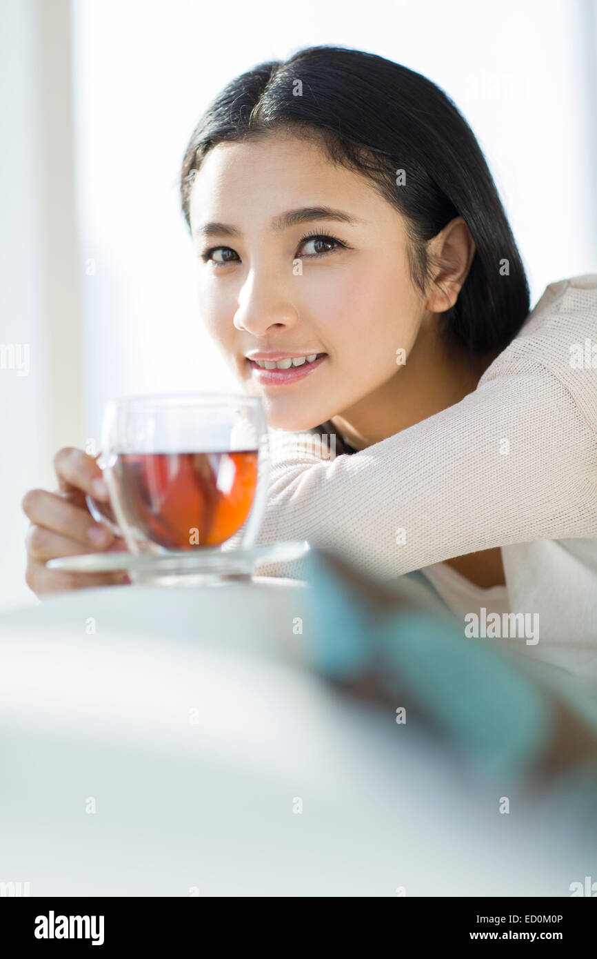 Happy young woman drinking black tea Stock Photo Alamy