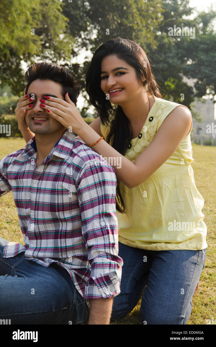 2 indian couple park fun Covering Eyes Stock Photo - Alamy