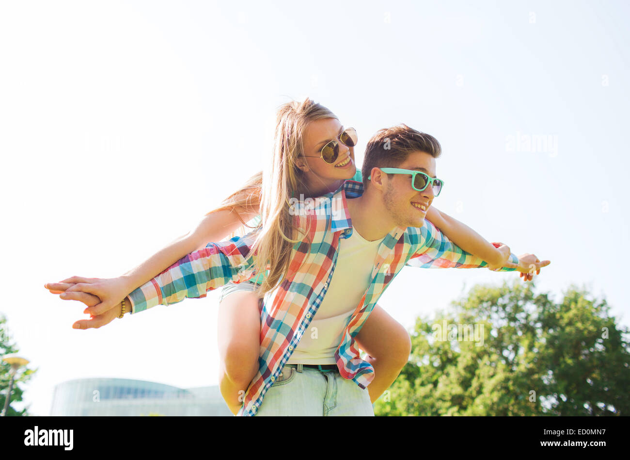 smiling couple having fun in park Stock Photo - Alamy