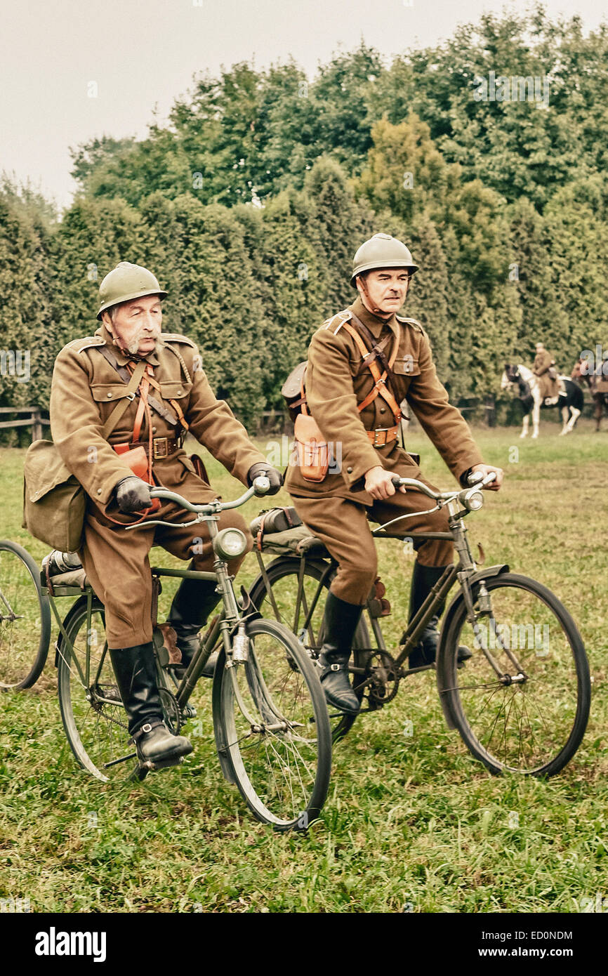 Polish soldiers riding a bicycle during WWII Battle of Lomianki - historical reenactment, Poland Stock Photo