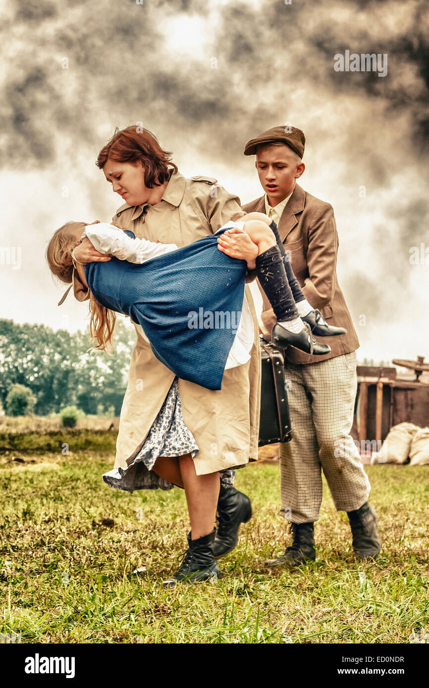 Polish civilians fleeing from aircraft bombing during WWII Battle of Lomianki - historical reenactment, Poland Stock Photo