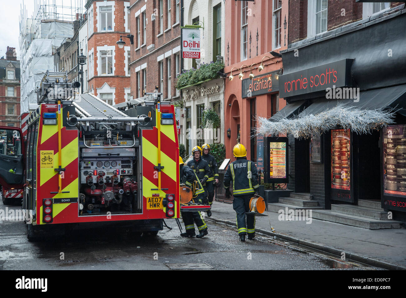 London, UK. 23 December, 2014. Six fire engines and 35 Firefighters dealing with a fire at the Delhi Patisserie, an Indian Restaurant next to Ronnie Scotts in Soho's Frith Street. Credit:  Pete Maclaine/Alamy Live News Stock Photo