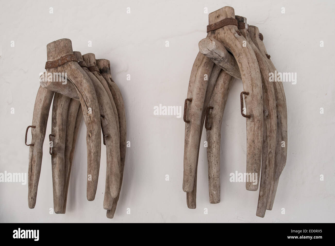 Ancient wooden yokes in a typical white wall of a country house in