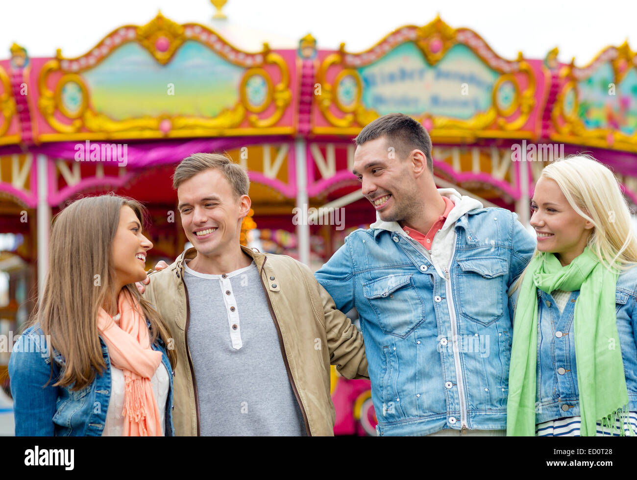 group of smiling friends in amusement park Stock Photo - Alamy