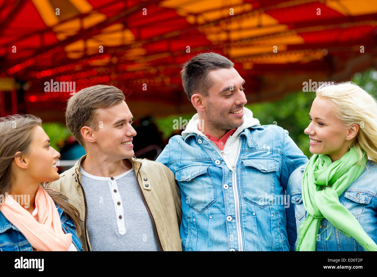 group of smiling friends in amusement park Stock Photo - Alamy