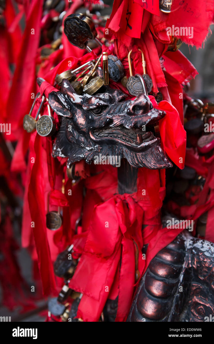 Love padlocks and red ribbons on a bridge with a dragon head at Tianmen ...