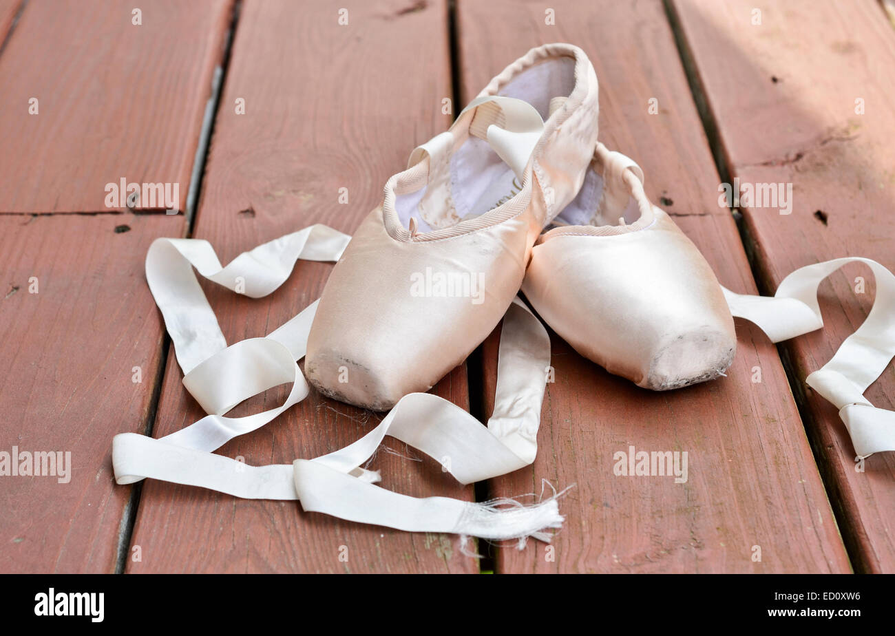 Worn ballet shoes on wooden floor Stock Photo - Alamy