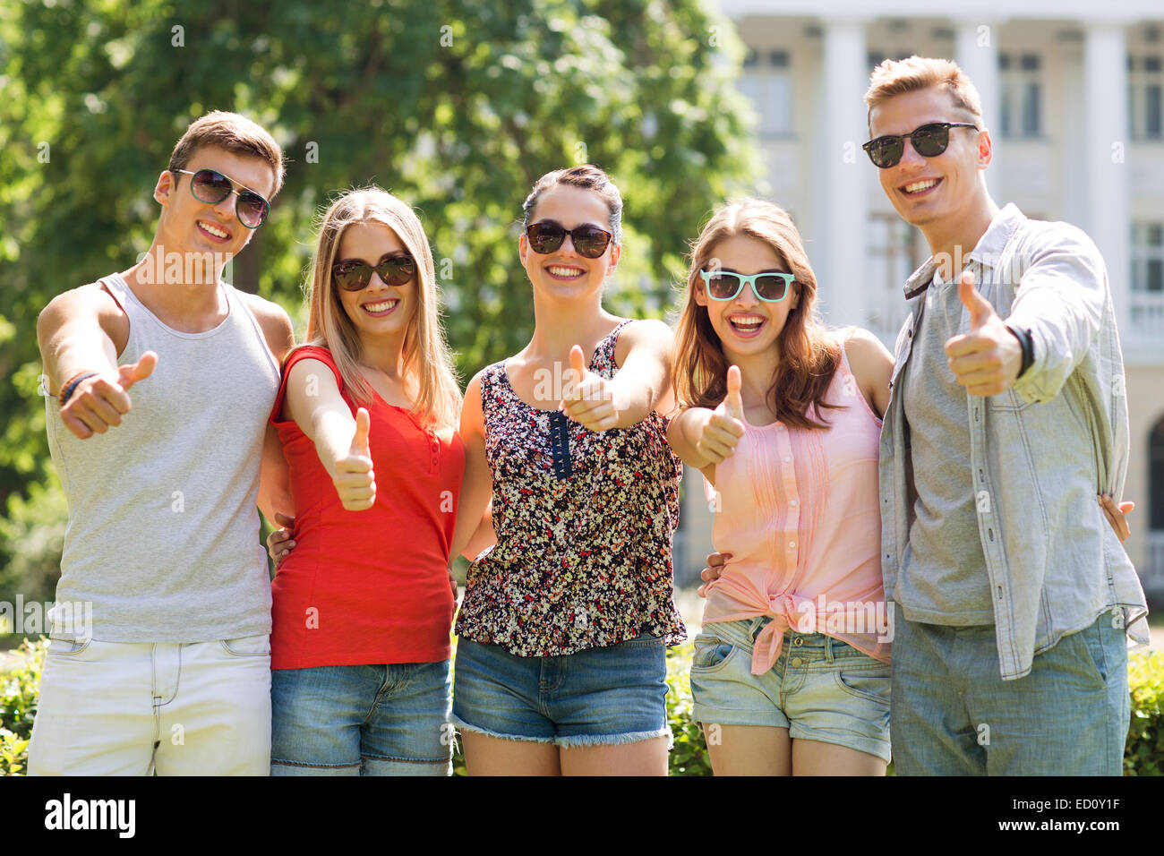 group of smiling friends showing thumbs up Stock Photo - Alamy