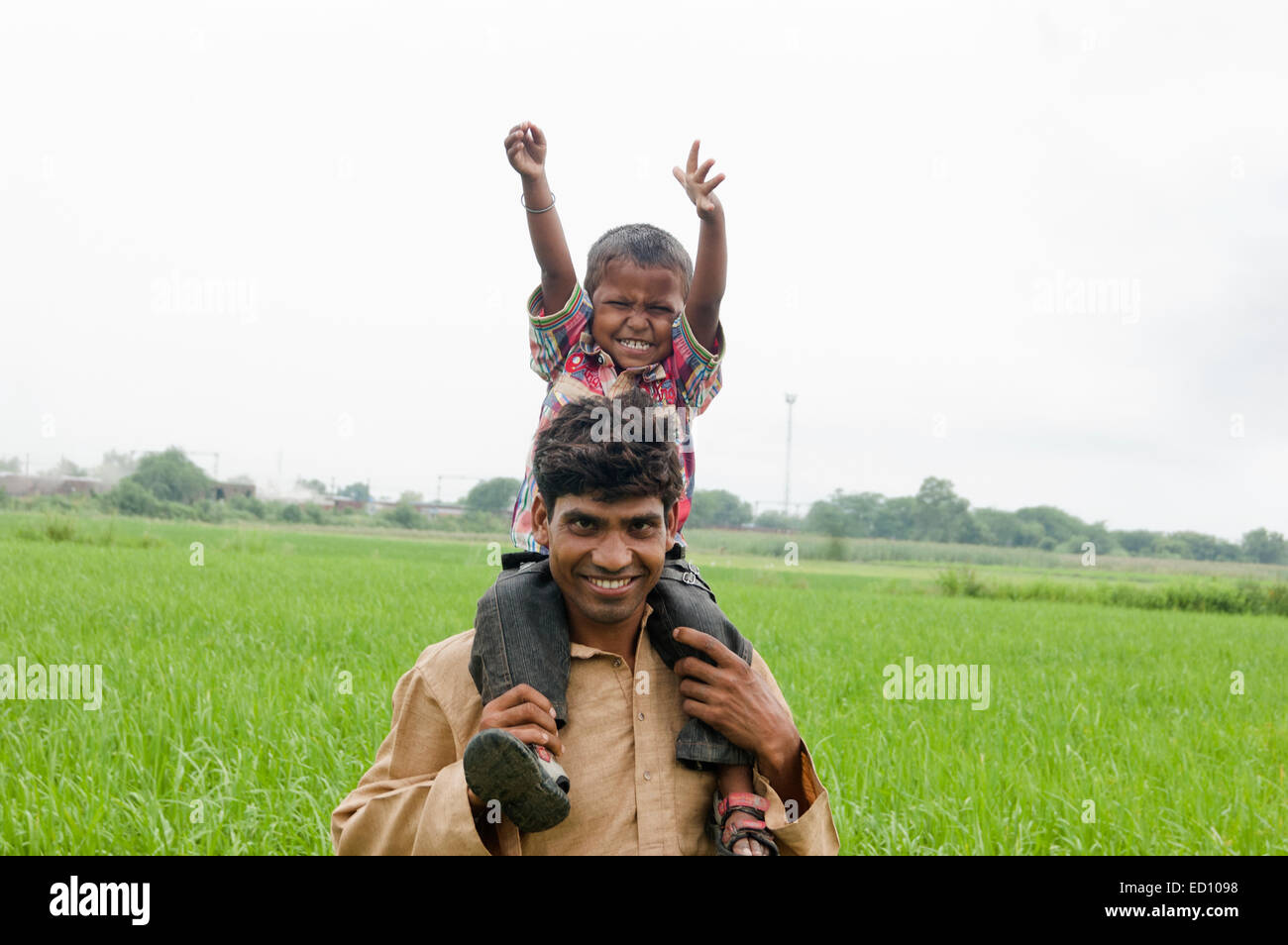 indian rural father with child field fun Stock Photo