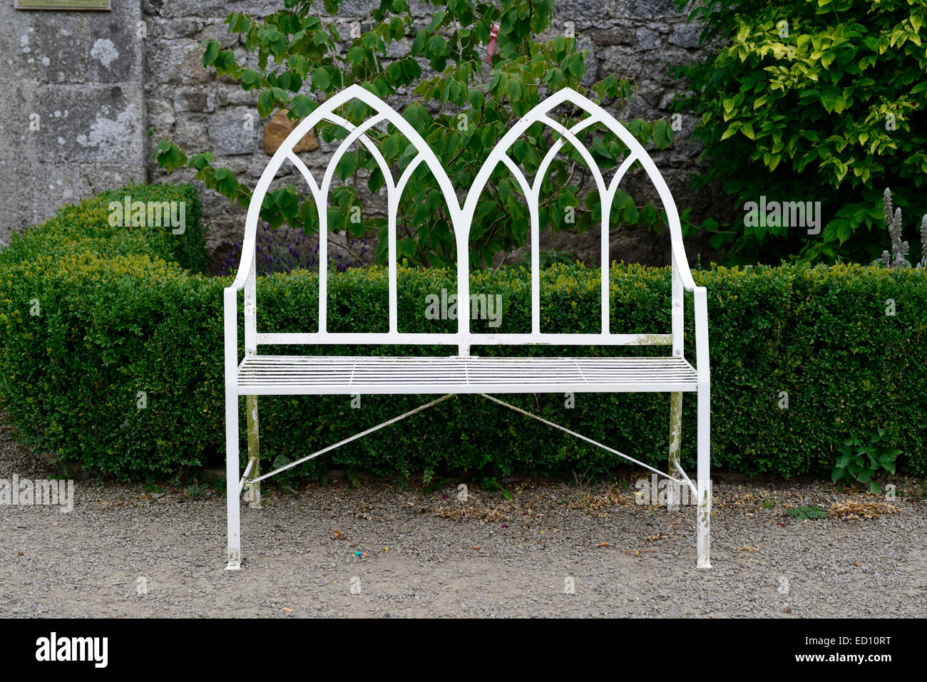 White garden seat seating two seater wrought iron metal bench gardening feature furniture features RM Ireland Stock Photo