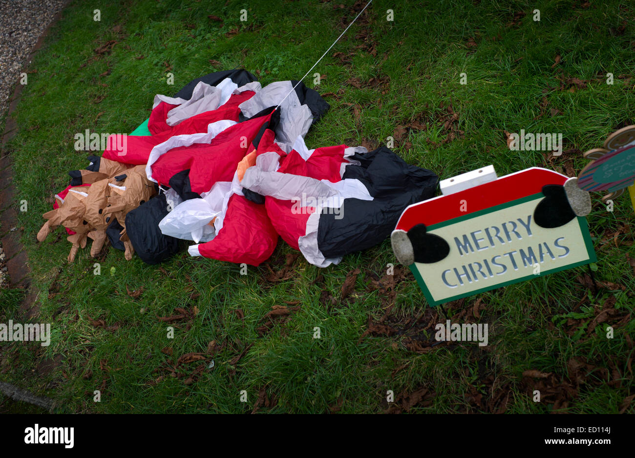 Sad Santa Claus in Broxted, Essex, England, UK. 23 December 2014 A deflated Santa Claus, Father Christmas, lies in a garden in Broxted, Essex,England, waiting for the big night on the 25th of December, Christmas Day. Stock Photo