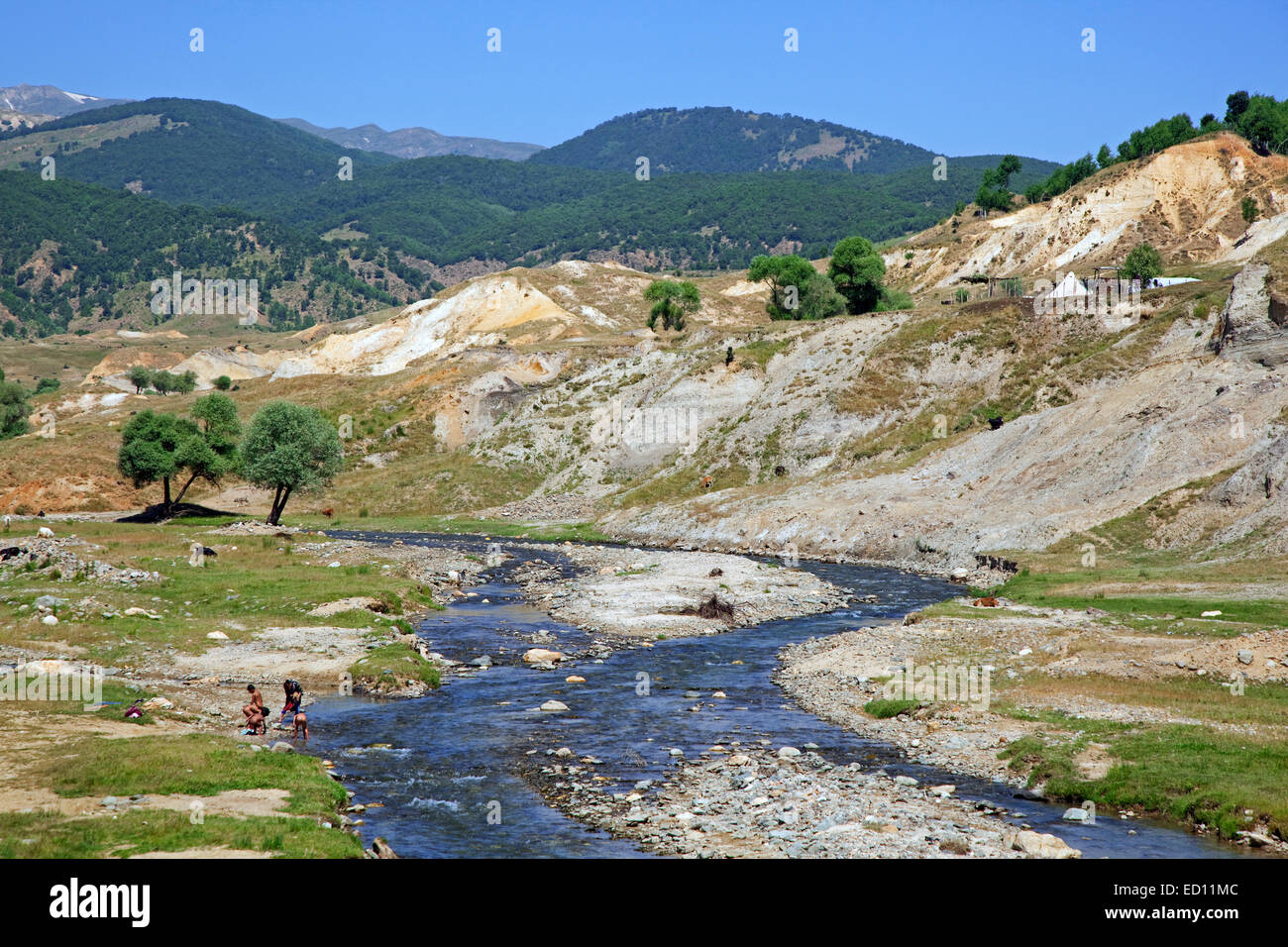 Nomad children washing in river near semi-nomad settlement in the mountains of Eastern Anatolia, Turkey Stock Photo