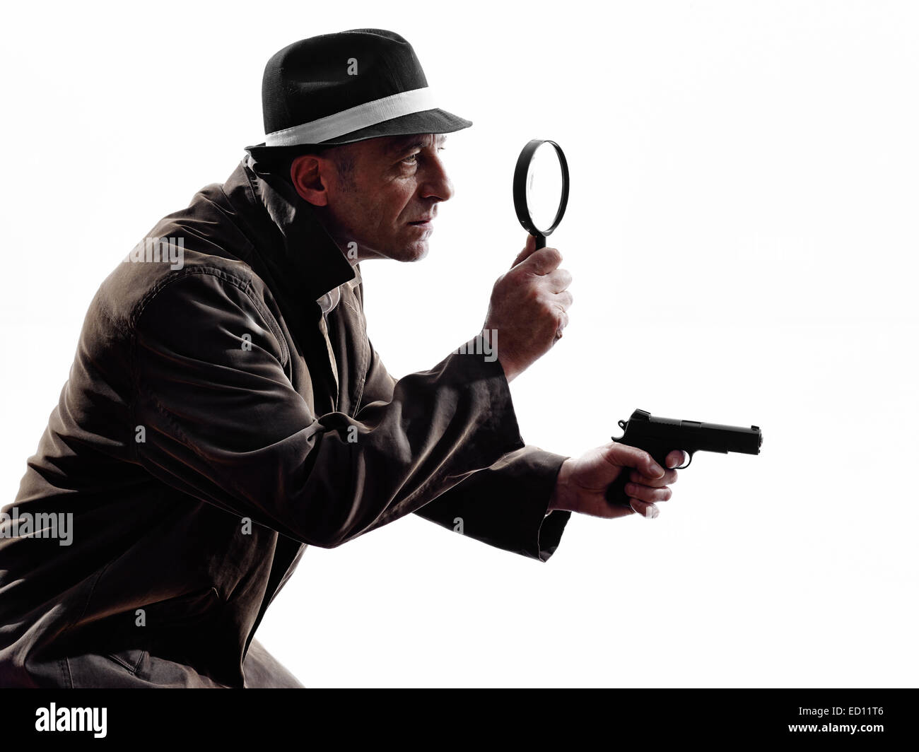 one detective man criminal investigations investigating crime in silhouette on white background Stock Photo