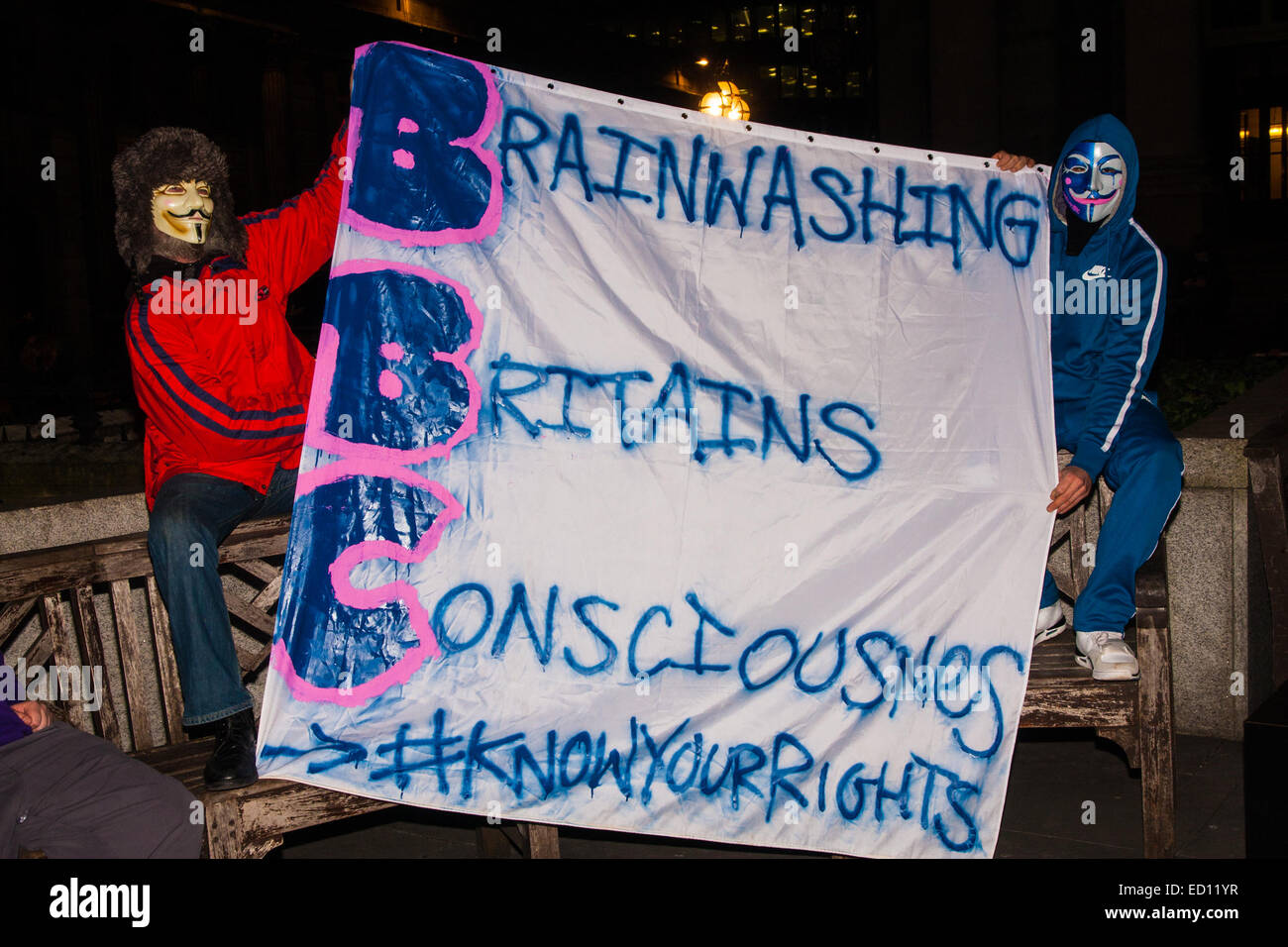 London, UK. 23rd Dec, 2014. Online activism group Anonymous march through London from the City to the BBC's HQ on Great Portland Street in protest against alleged biases and coverups of a 'paedophile ring'. PICTURED: Protesters made up their own versions of the BBC acronym. Credit:  Paul Davey/Alamy Live News Stock Photo