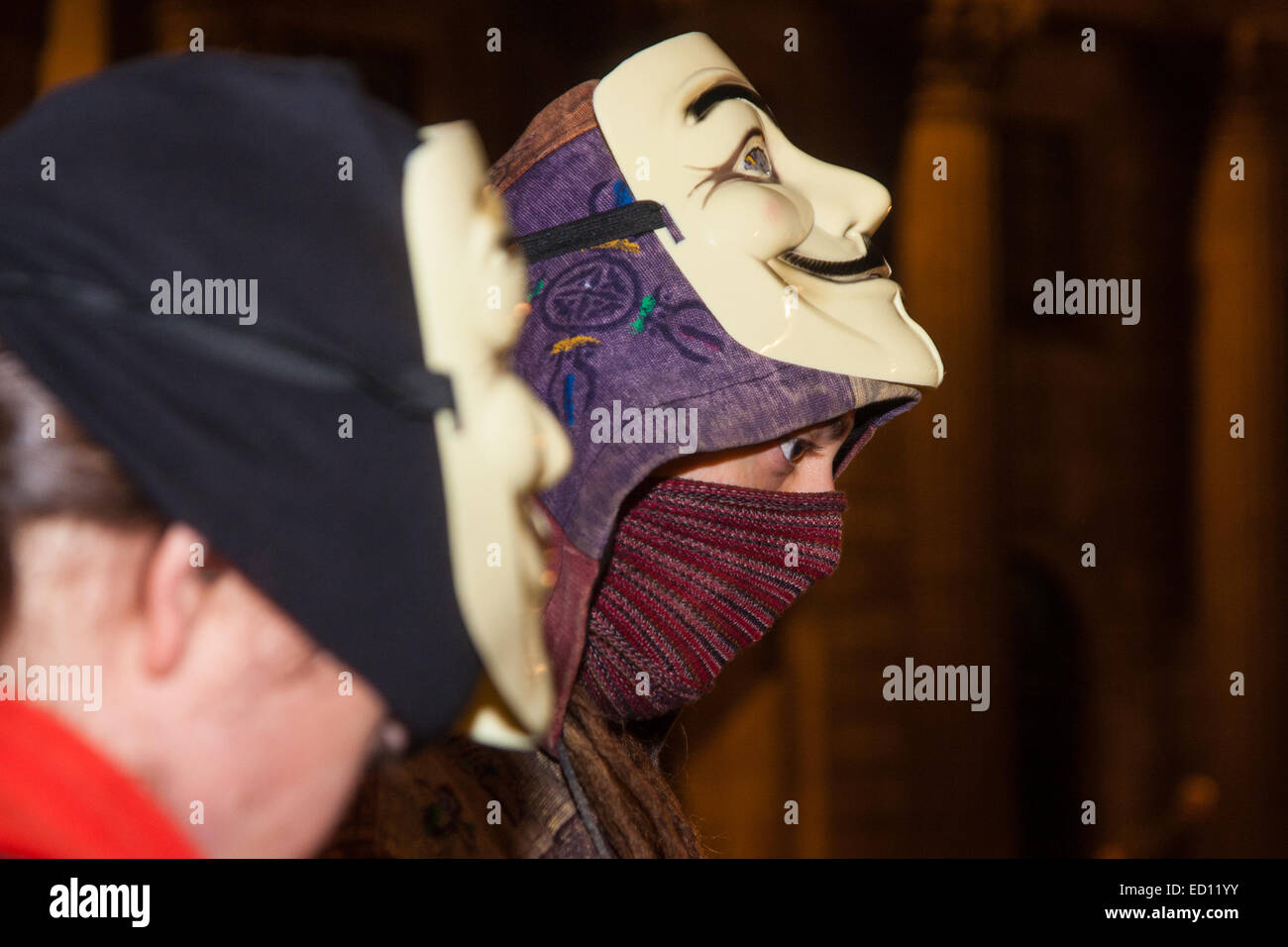 London, UK. 23rd Dec, 2014. Online activism group Anonymous march through London from the City to the BBC's HQ on Great Portland Street in protest against alleged biases and coverups of a 'paedophile ring'. PICTURED: Protesters await the beginning of their march outside the Bank of England. Credit:  Paul Davey/Alamy Live News Stock Photo