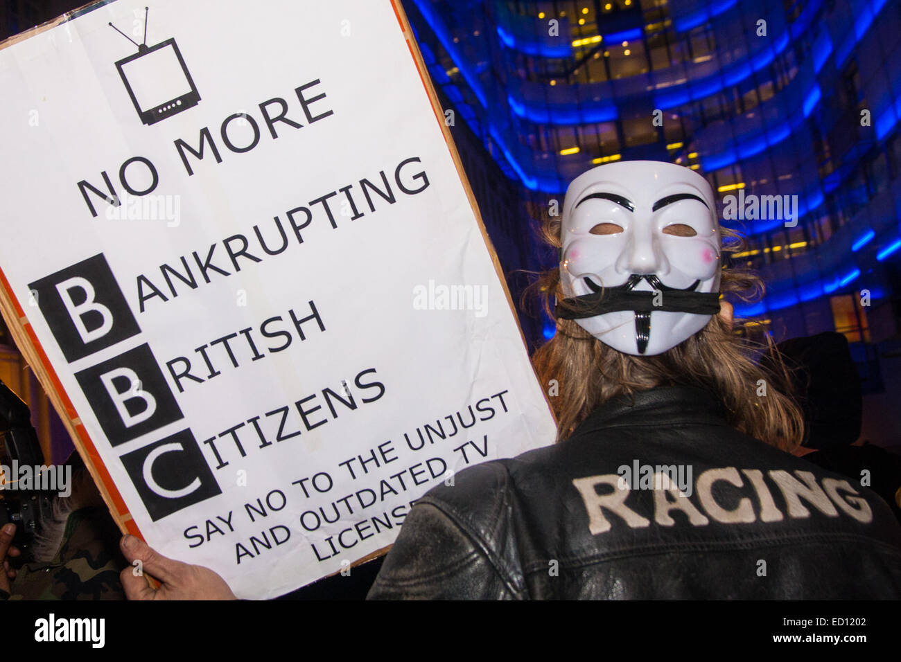 London, UK. 23rd Dec, 2014. Online activism group Anonymous march through London from the City to the BBC's HQ on Great Portland Street in protest against alleged biases and coverups of a 'paedophile ring'. PICTURED: Some Anonymous activists protest against the BBC's licence fee. Credit:  Paul Davey/Alamy Live News Stock Photo