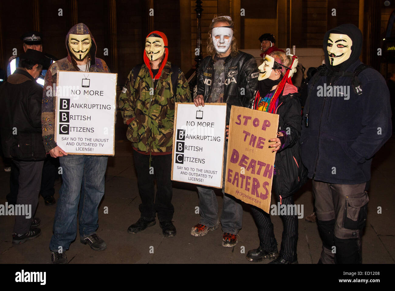 London, UK. 23rd Dec, 2014. Online activism group Anonymous march through London from the City to the BBC's HQ on Great Portland Street in protest against alleged biases and coverups of a 'paedophile ring'. PICTURED: Protesters await the beginning of their march outside the Royal Exchange Credit:  Paul Davey/Alamy Live News Stock Photo
