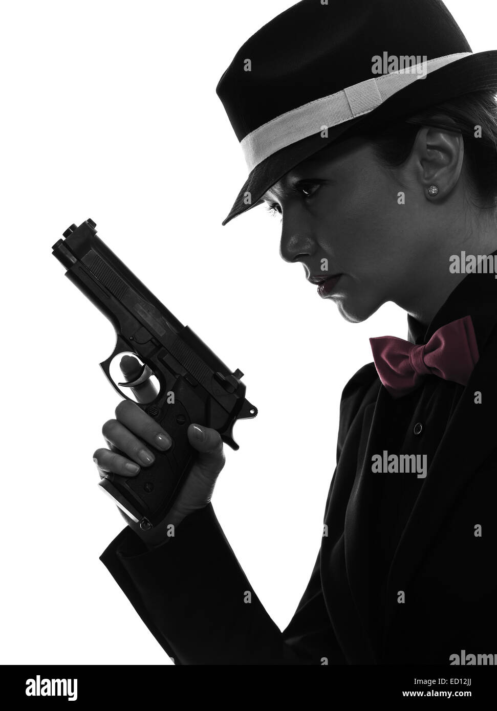 one stylish  woman in suit holding gun in silhouette on white background Stock Photo