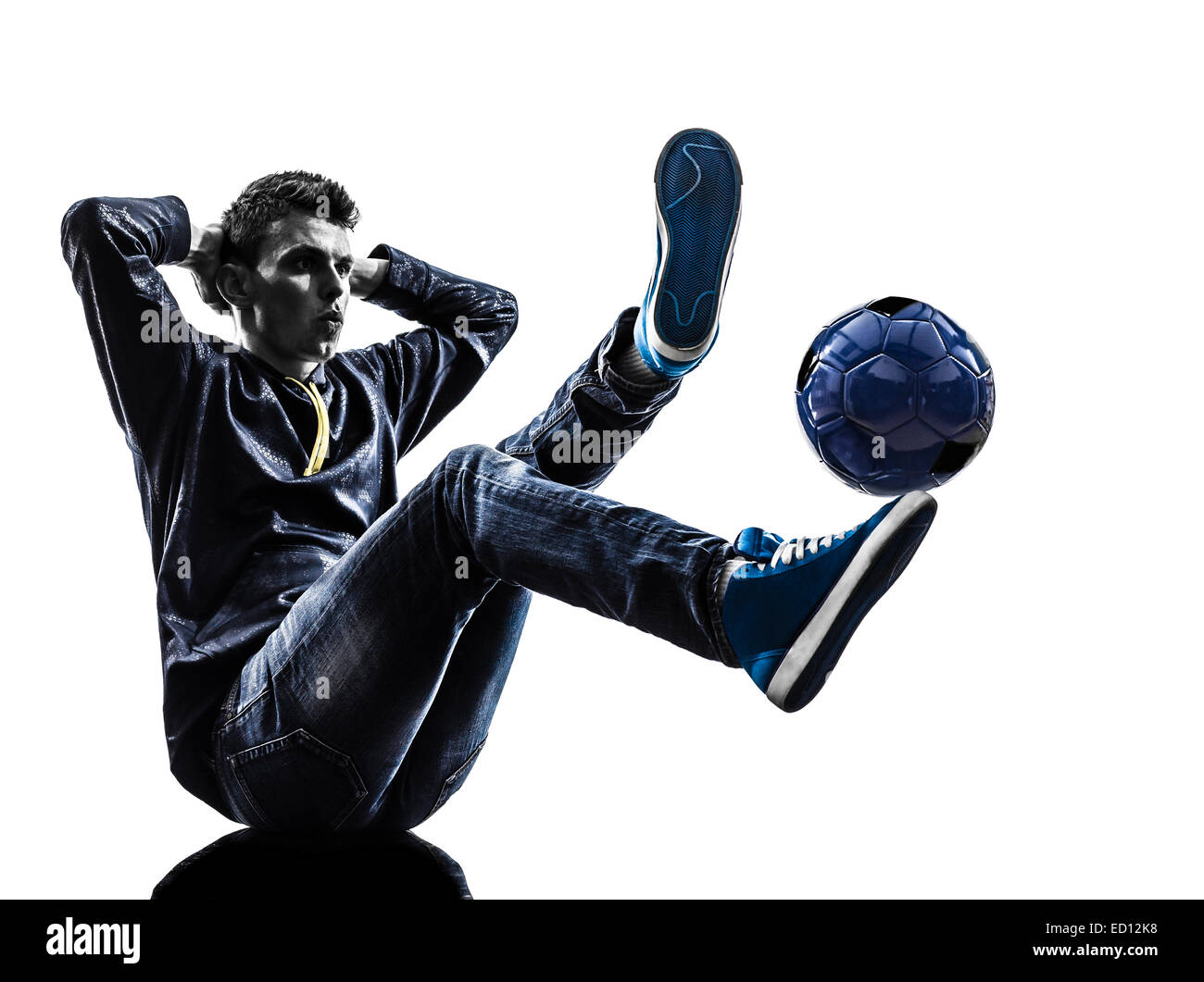 one young man soccer freestyler player in silhouette on white