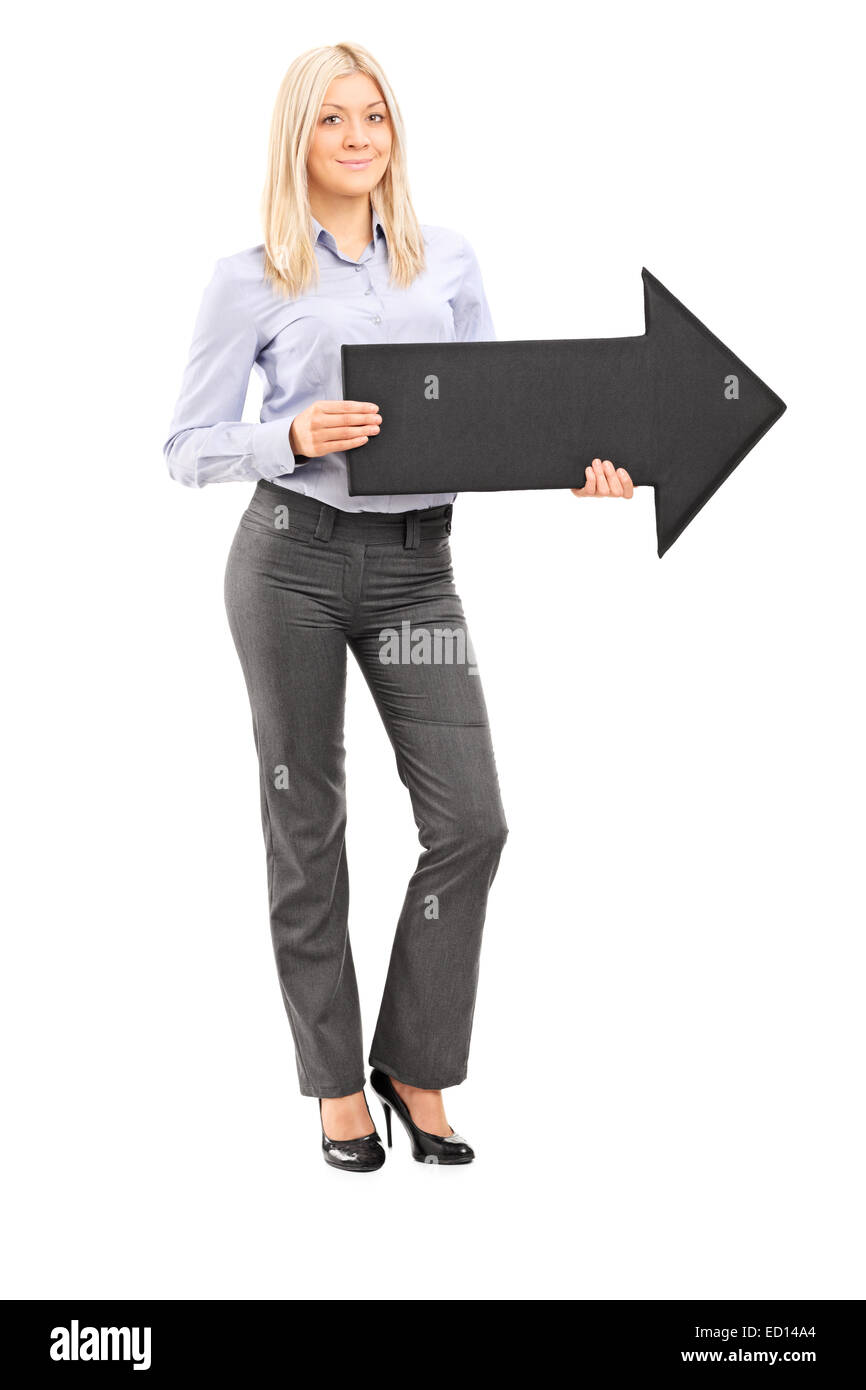 Full length portrait of a blond smiling woman holding a big black arrow ...