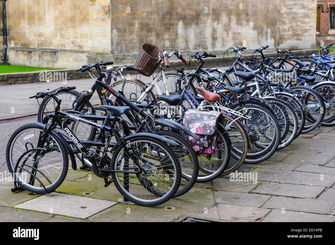Bicycles parked at a bike rack in Cambridge Cambridgeshire England United Kingdom UK Stock Photo