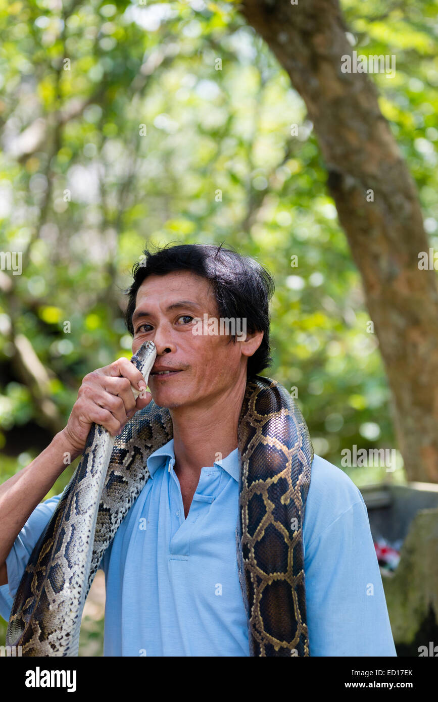 Man with pet snake in Mekong Delta, Vietnam Stock Photo Alamy