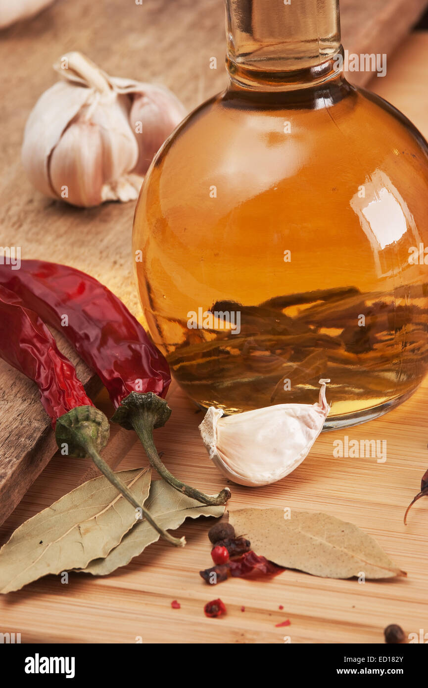 bottle with marinade and spices  on a wooden table Stock Photo