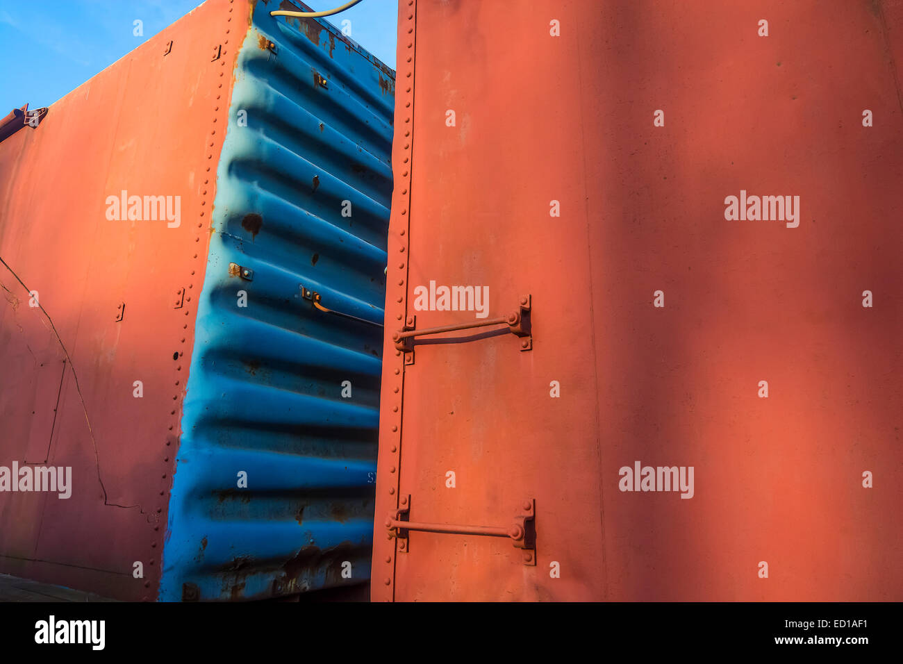 Colorful orange and blue railroad freight cars. Stock Photo