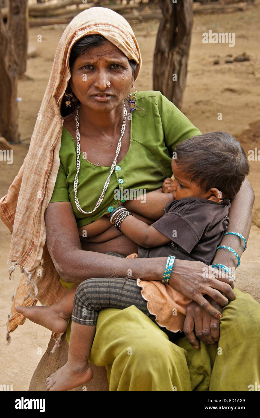 Woman of Adivasi tribe nursing her child in village near Poshina, Gujarat, India Stock Photo