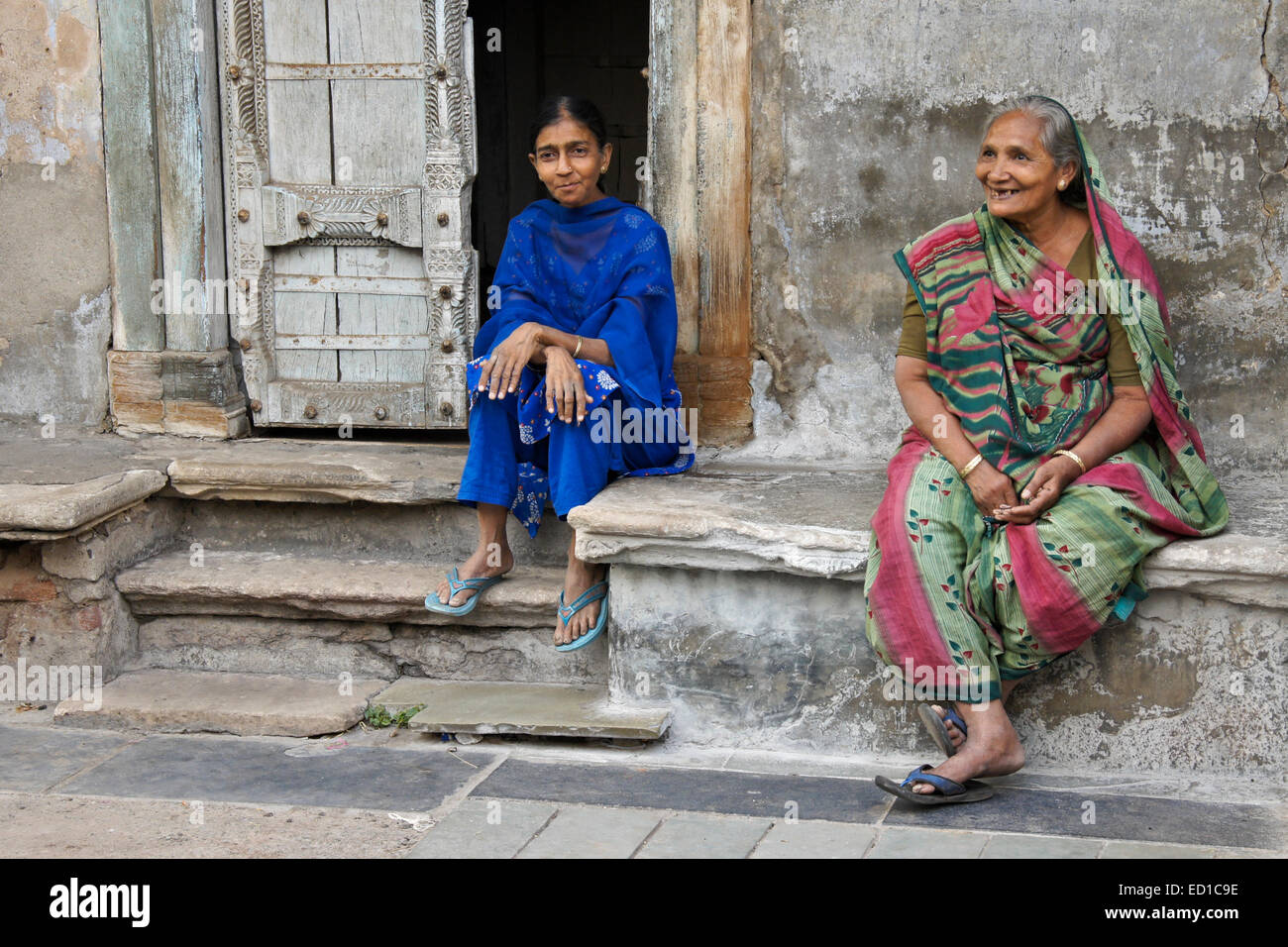 Women sitting outside home in Old Ahmedabad, Gujarat, India Stock Photo