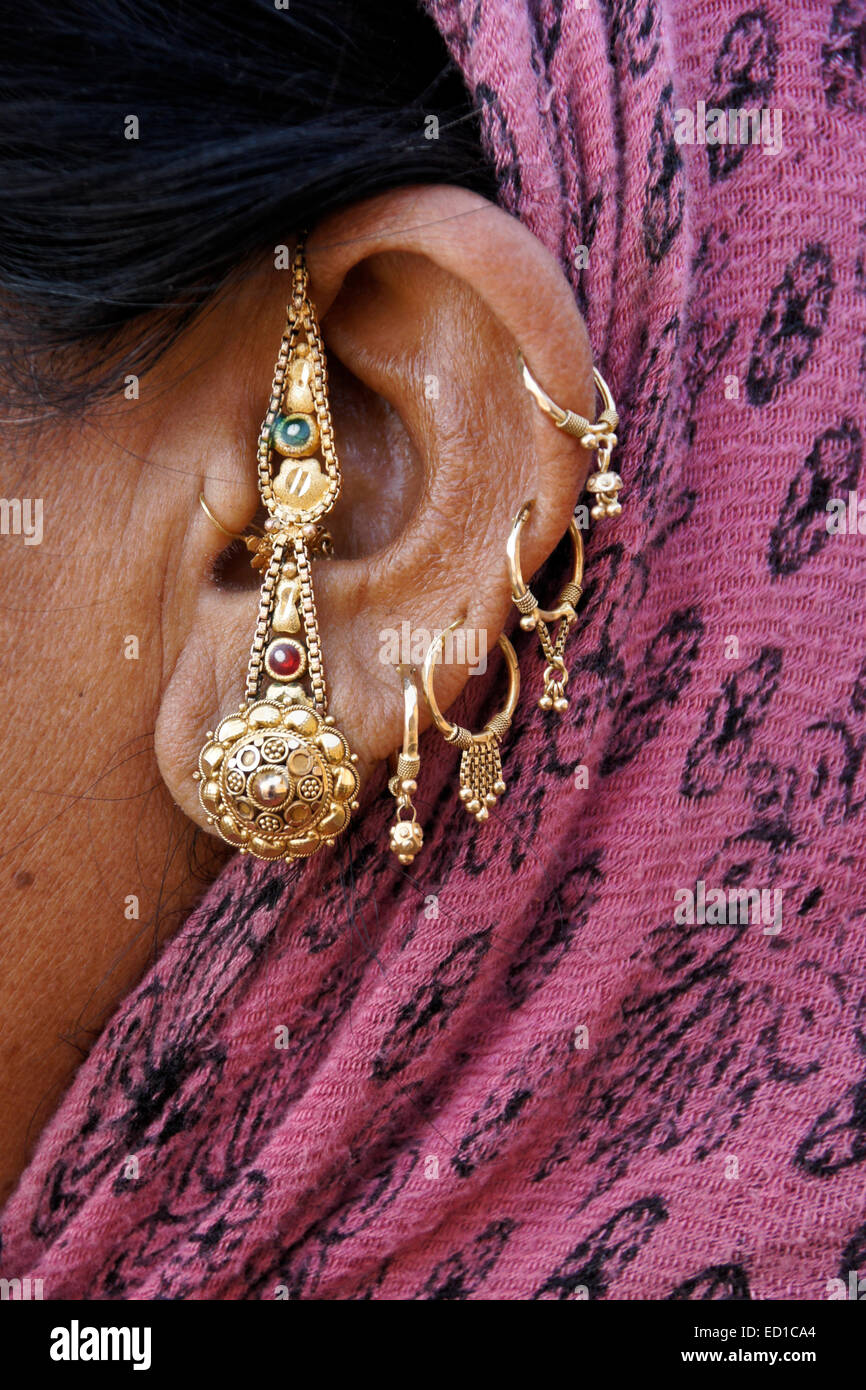 Gold adornments on ear of Gujarati woman, Patan, Gujarat, India Stock Photo