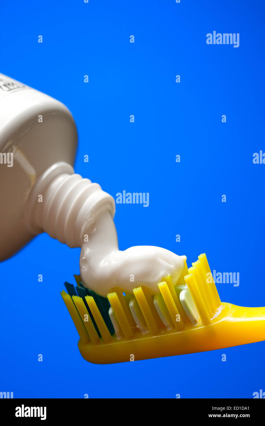Toothbrush and toothpaste on a blue background Stock Photo Alamy