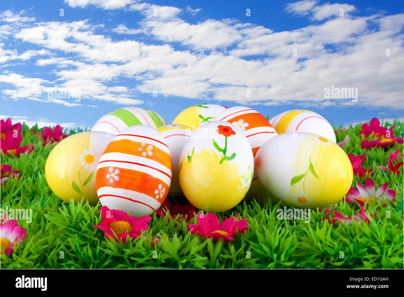 colorful painted easter eggs located on a green meadow with flowers in ...