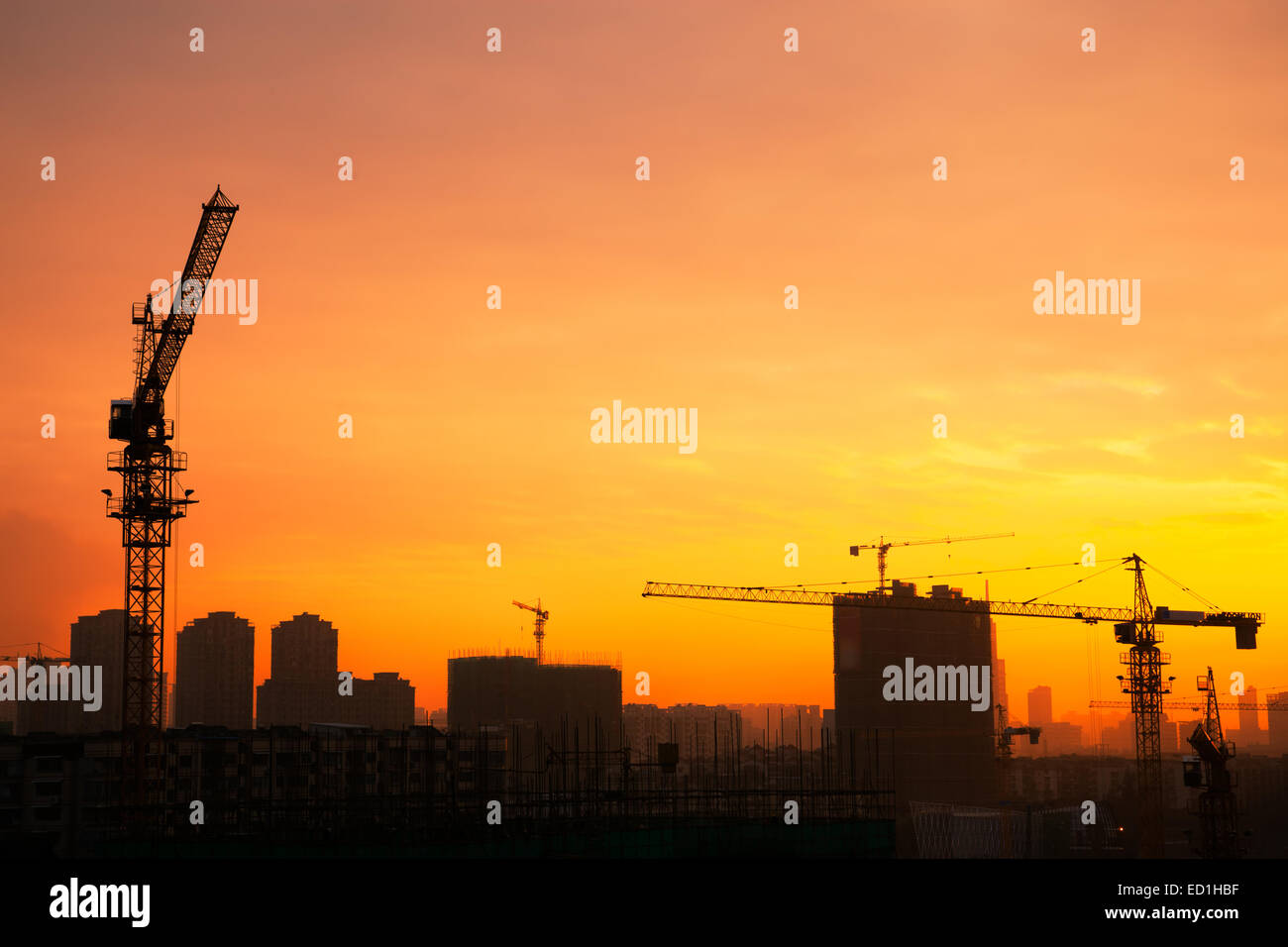Silhouette of the tower crane on the construction site with city ...