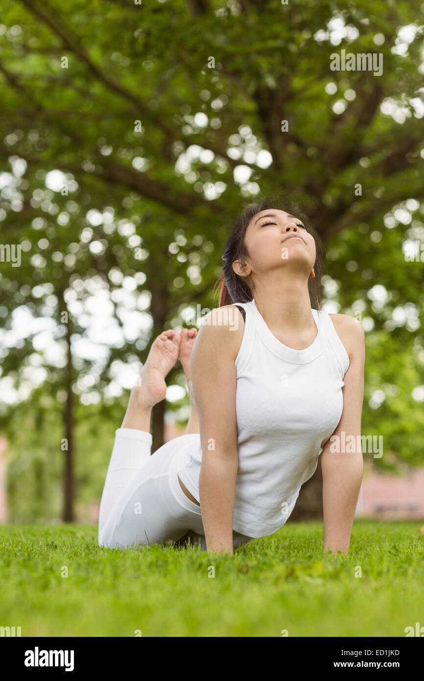Healthy woman doing stretching exercises at park Stock Photo