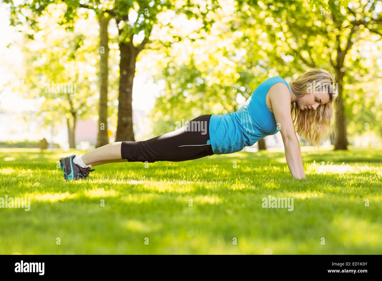 Fit blonde doing push ups in the park Stock Photo - Alamy