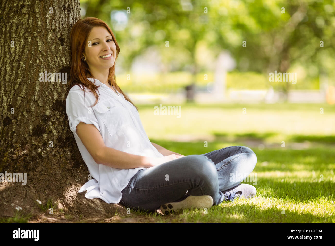 Pretty redhead sitting in casual clothing Stock Photo