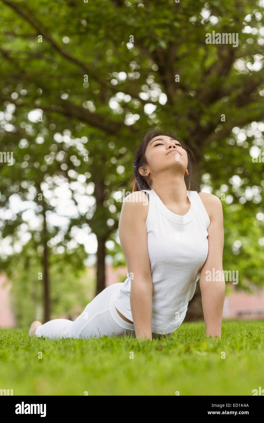 Woman doing stretching exercises at park Stock Photo