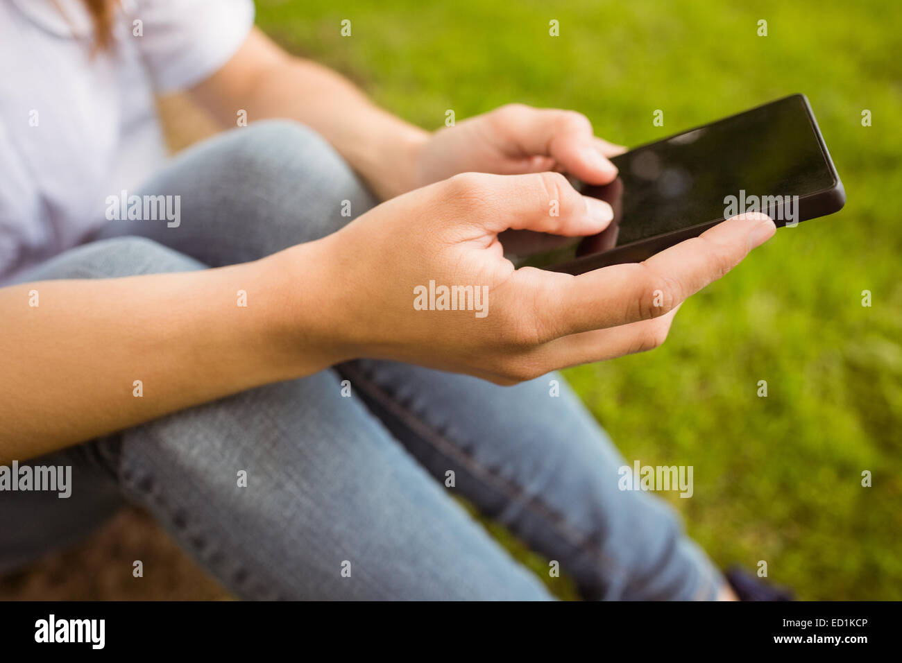 Mid section of a pretty redhead texting Stock Photo - Alamy