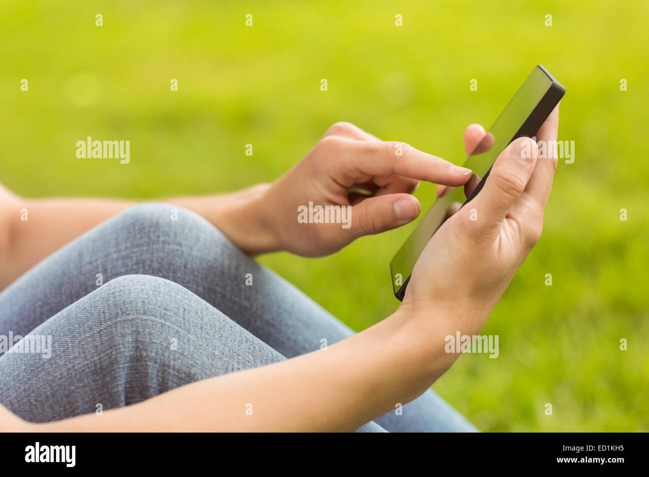 Mid section of a pretty redhead texting Stock Photo - Alamy