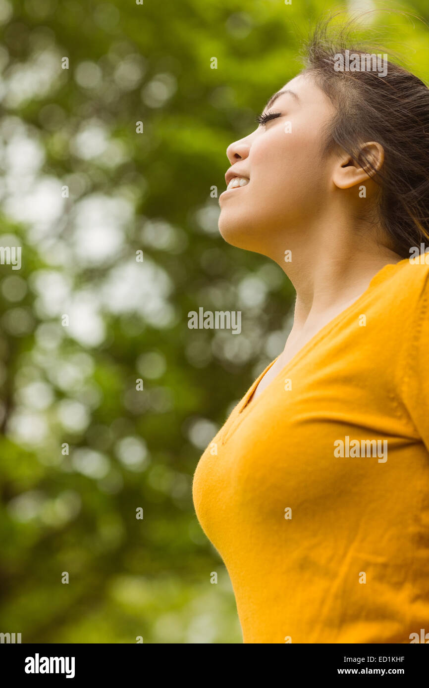 Beautiful woman with eyes closed in park Stock Photo - Alamy