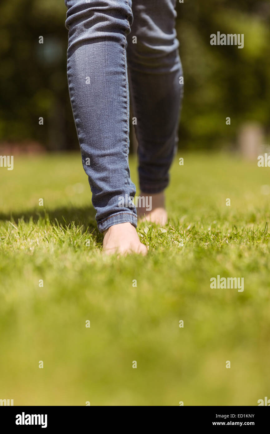 Woman walking barefoot grass feet hi-res stock photography and images ...
