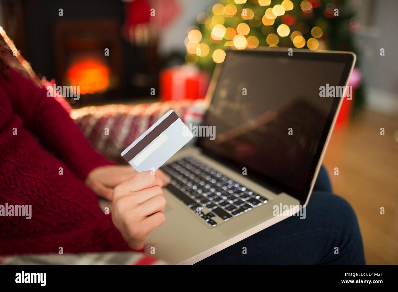 Woman shopping online with laptop at christmas Stock Photo