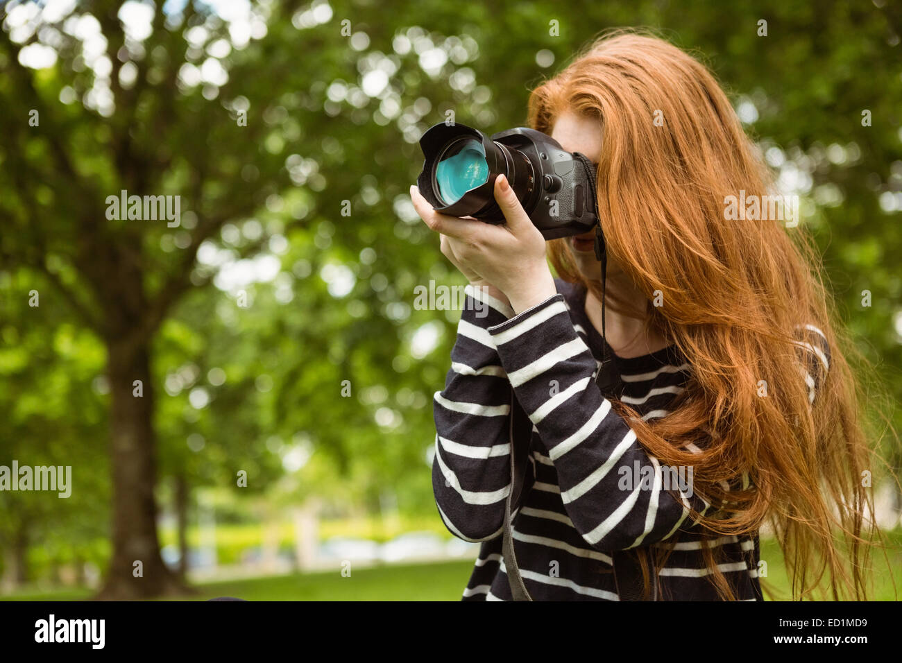 Female photographer at park Stock Photo