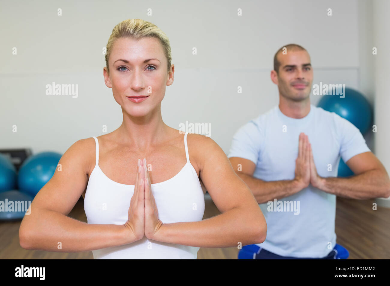 Sporty couple with joined hands at fitness studio Stock Photo