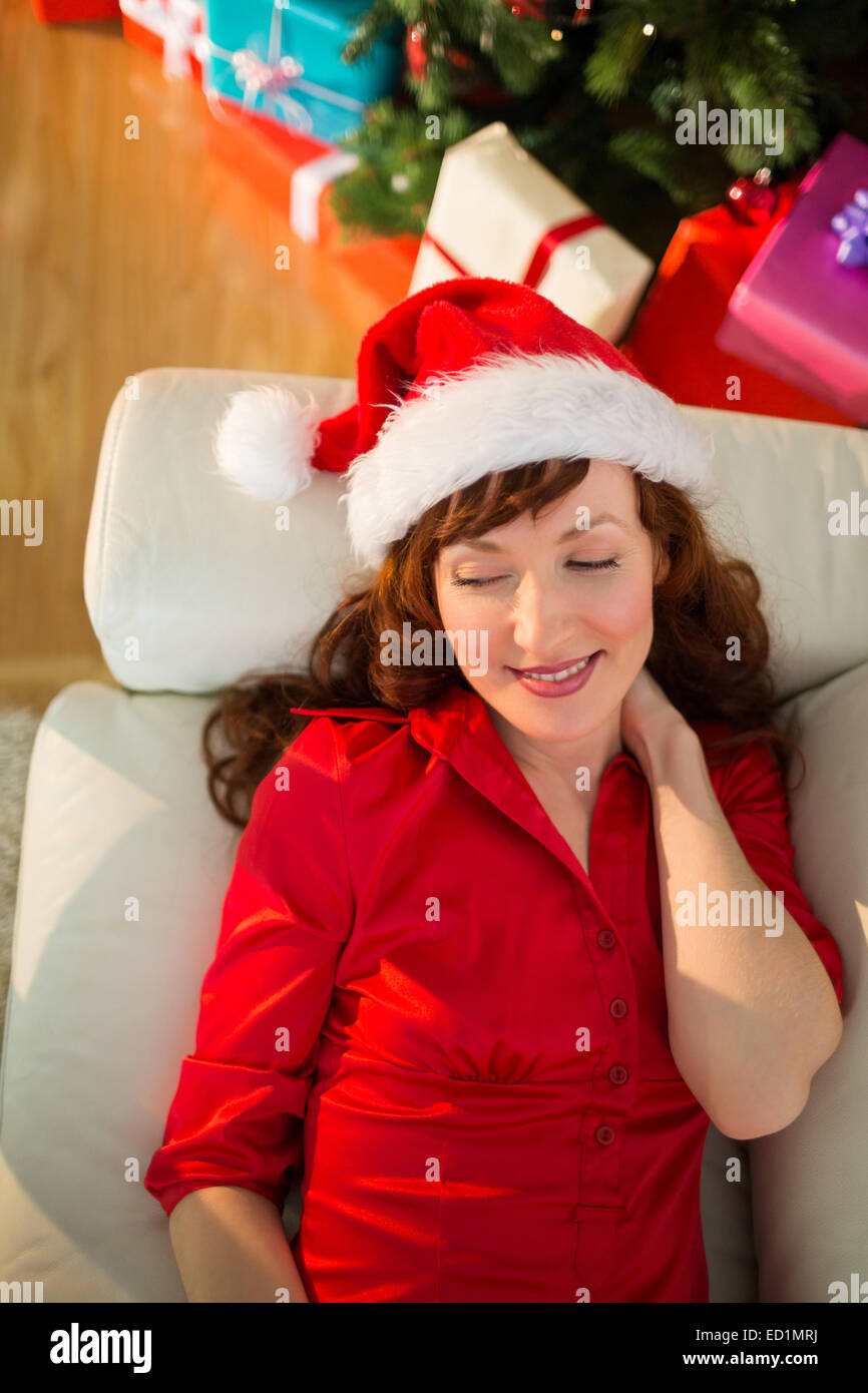 Relaxed redhead lying on the sofa at christmas Stock Photo