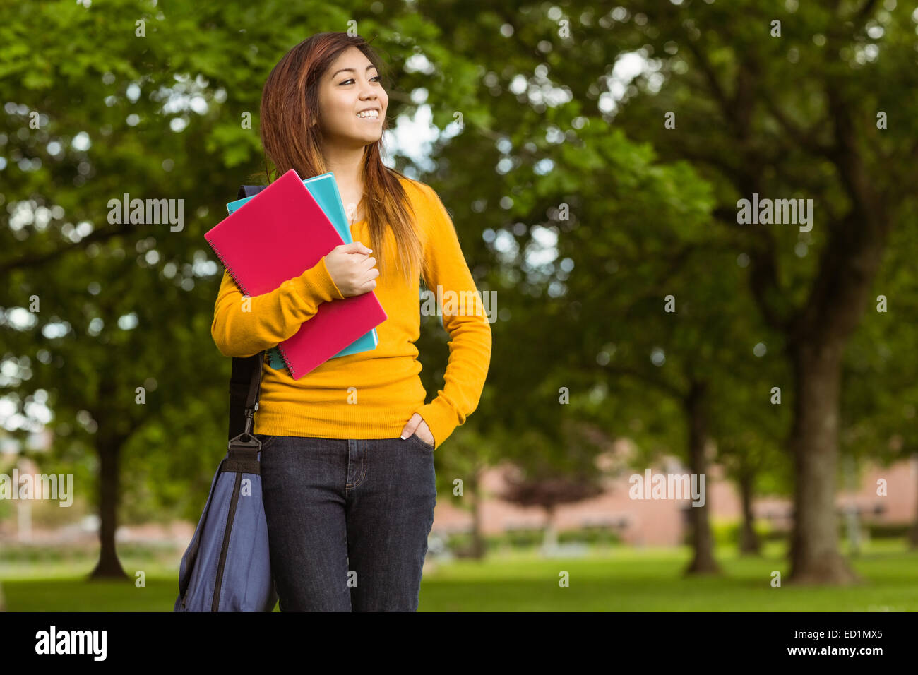 Female college student with books in park Stock Photo