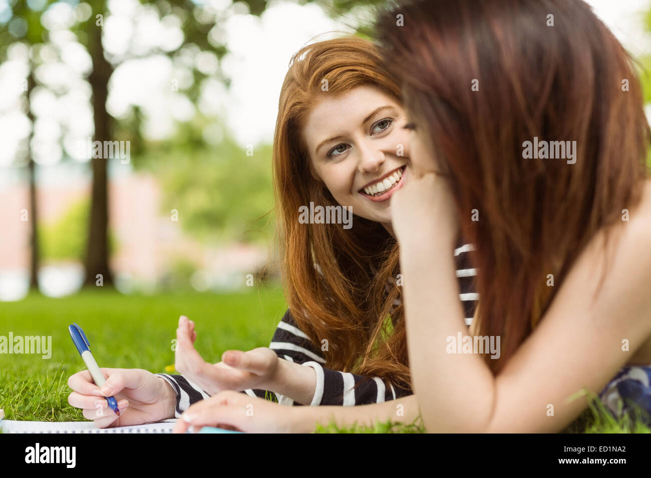 Female students with books in park Stock Photo - Alamy
