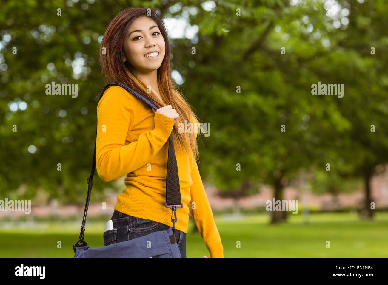 Female college student with bag in park Stock Photo