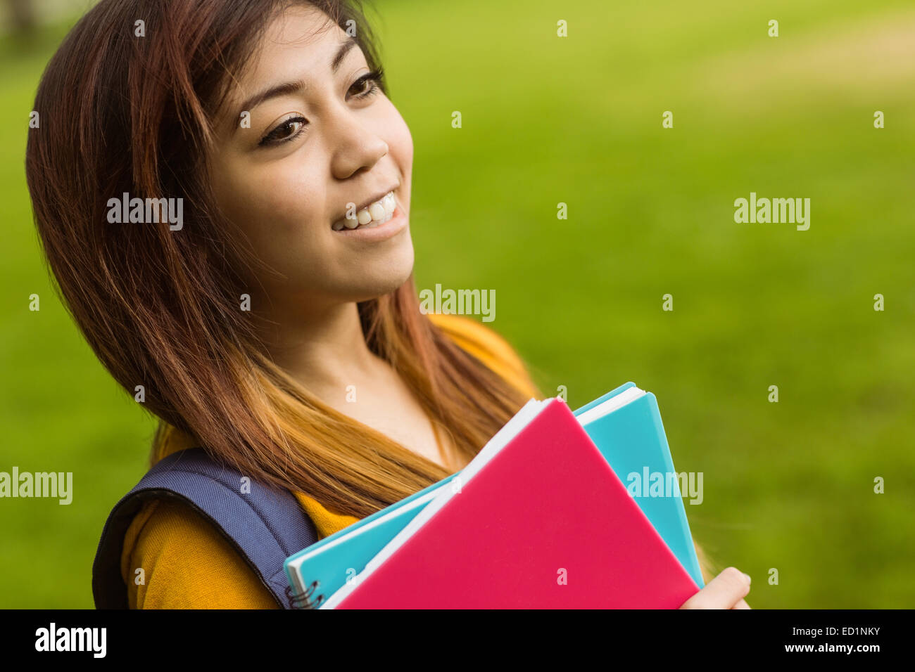 Female college student with books in park Stock Photo - Alamy